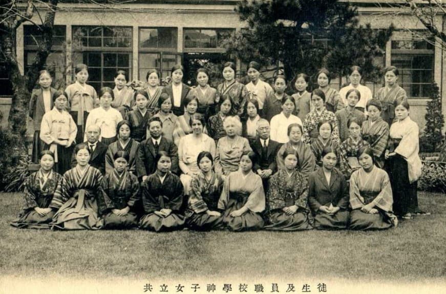 Vintage group portrait of students and staff at Kyoritsu Women's Theological School outdoors.